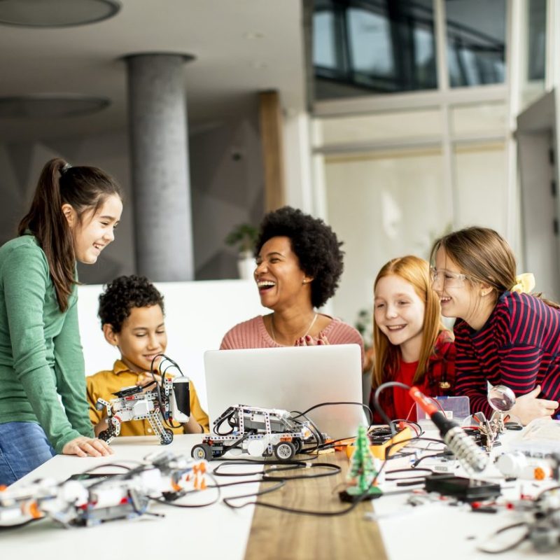 group-of-happy-kids-with-their-african-american-female-science-teacher.jpg