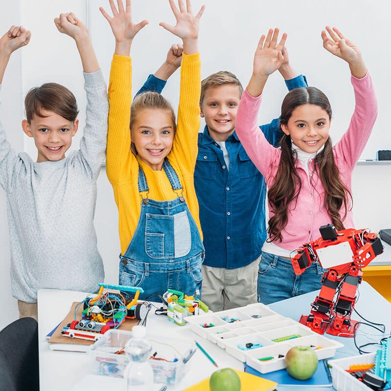 happy-schoolchildren-with-raising-hands-standing-a-2023-11-27-05-16-01-utc