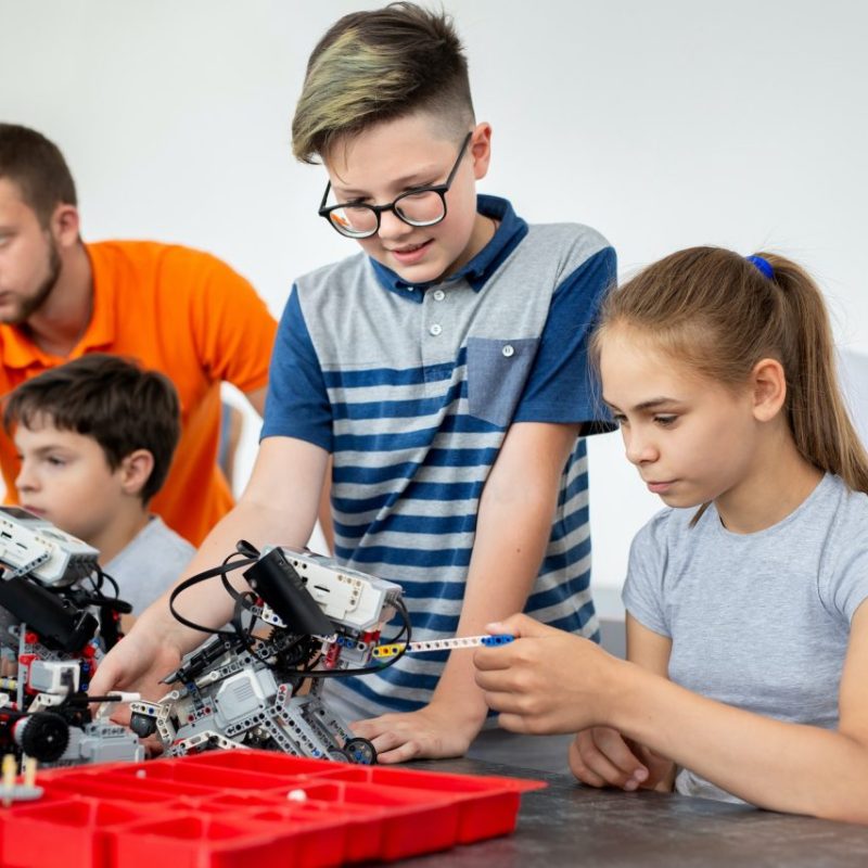 kids-working-with-teacher-on-their-robot-education-project-.jpg