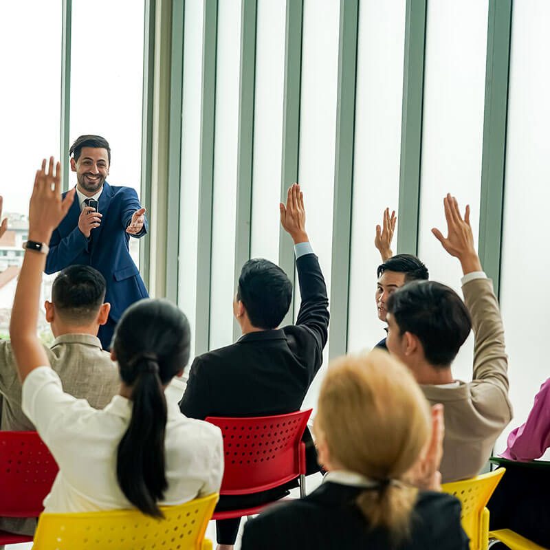 raised-up-hands-of-large-group-in-seminar-class-ro-2023-11-27-04-49-25-utc