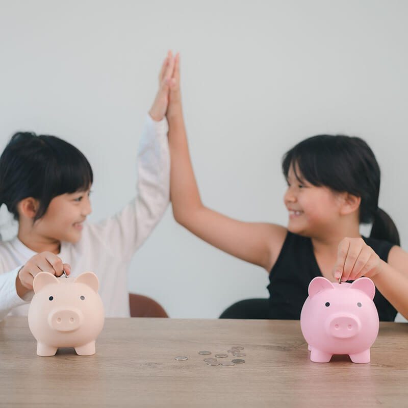 two-asian-little-girls-having-fun-to-put-coin-into-2023-11-27-05-09-53-utc